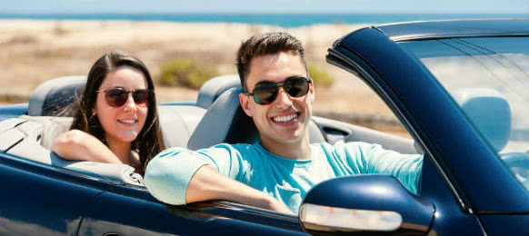 man driving his car rental at noosa beach
